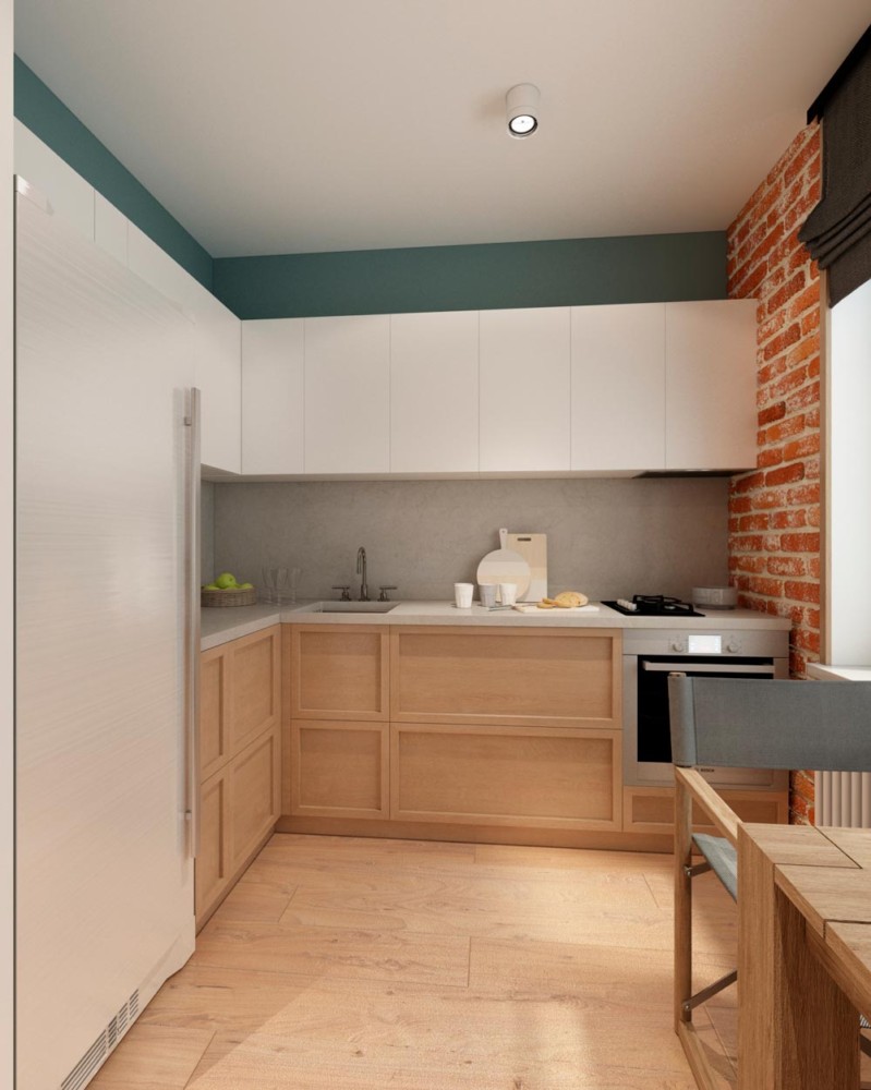 Кухонная зона получилась динамичной, умело разграничиваясь с основным пространством квартиры, за счет кирпичной кладки расположенной у окна. Внося яркое цветовое разнообразие в основное цветовое решение кухни.